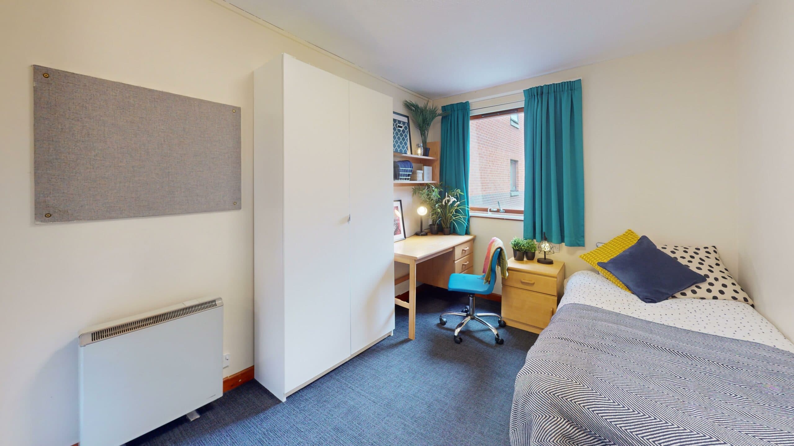 Standard bedroom at Albion House with a desk, wardrobe and single bed